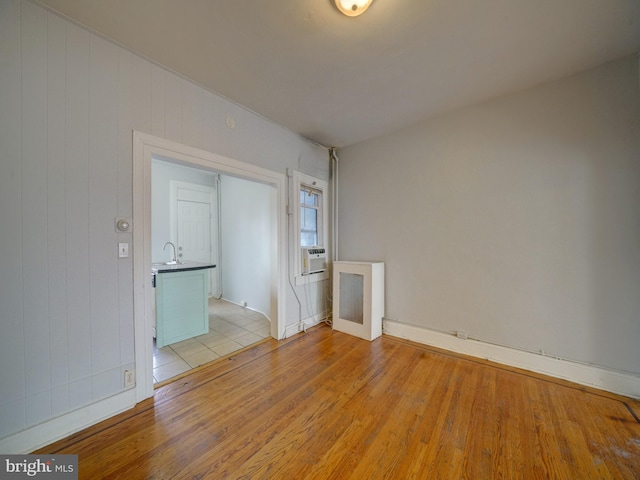 spare room with light hardwood / wood-style flooring and cooling unit