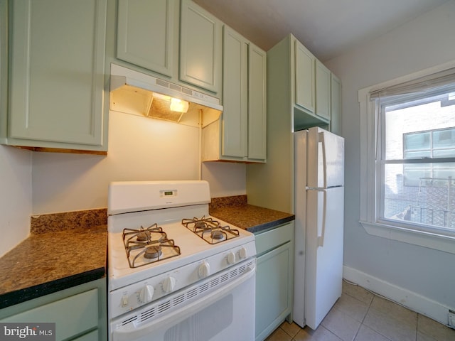 kitchen featuring white appliances, green cabinets, and light tile patterned flooring