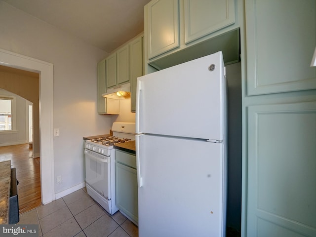 kitchen with white appliances and light tile patterned floors