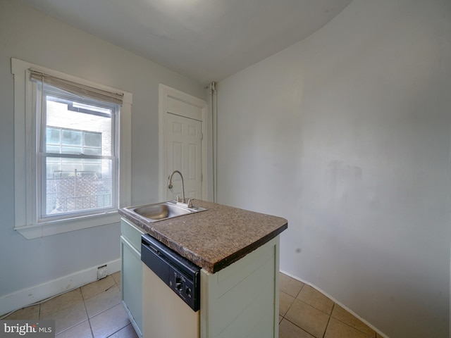 kitchen featuring dishwasher, light tile patterned floors, a center island with sink, and sink