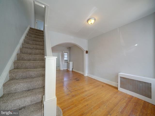 stairway featuring wood-type flooring