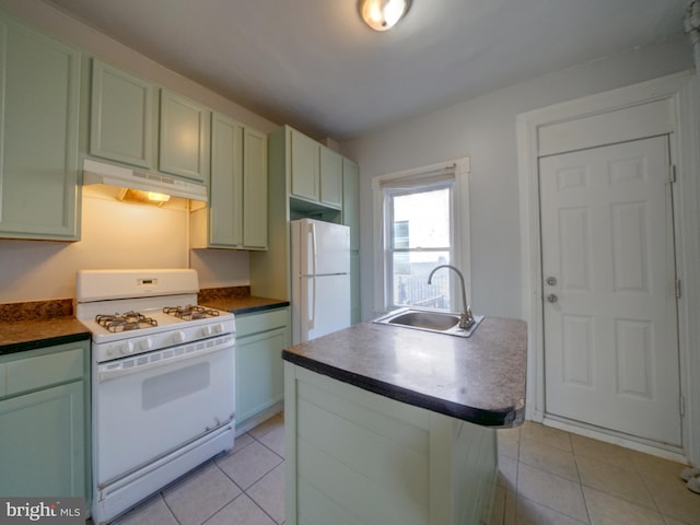 kitchen with green cabinets, sink, light tile patterned floors, and white appliances