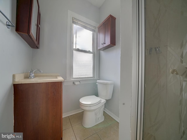 bathroom featuring toilet, vanity, and tile patterned floors