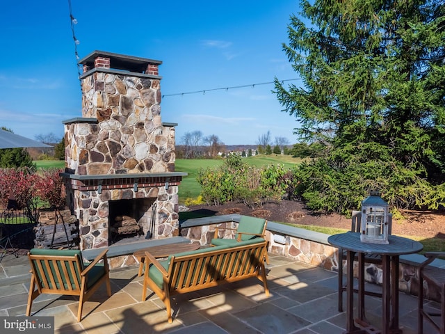 view of patio / terrace featuring an outdoor living space with a fireplace