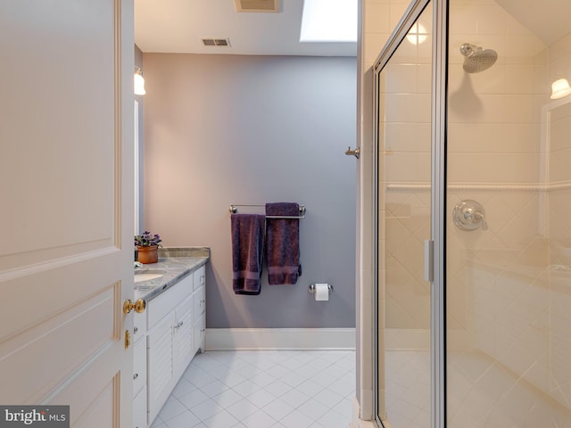 bathroom with tile patterned floors, a shower with door, and vanity