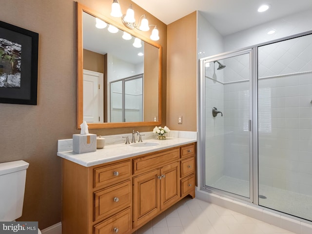 bathroom with vanity, toilet, and walk in shower