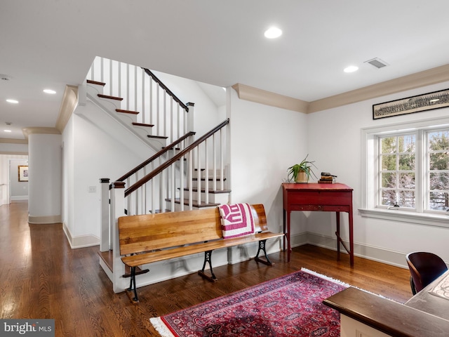 interior space with dark hardwood / wood-style flooring and crown molding