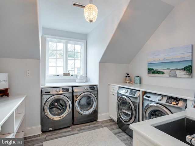 laundry area with cabinets, sink, and washer and dryer