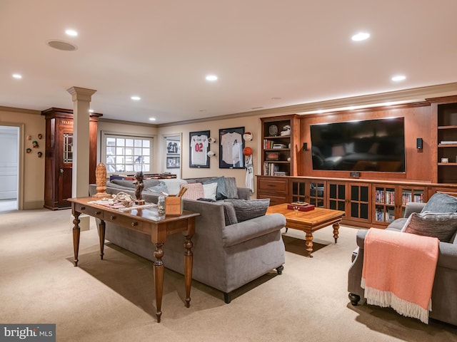 carpeted living room with decorative columns, built in shelves, and crown molding