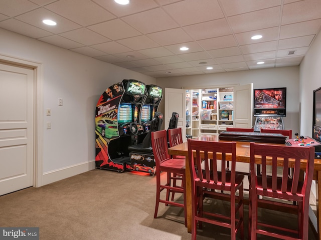 dining room with carpet flooring and a drop ceiling