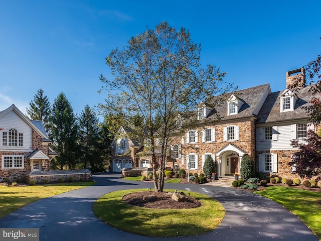 view of front of house with a front yard and a garage