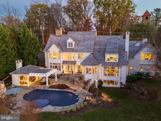 rear view of property featuring a patio and area for grilling