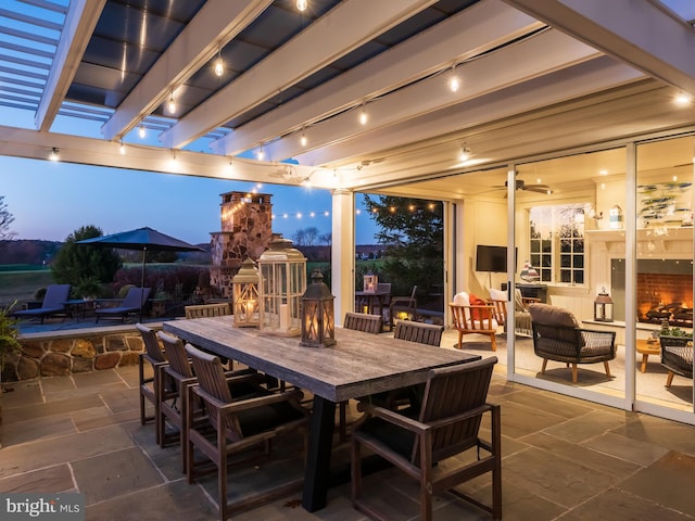 patio terrace at dusk featuring a pergola