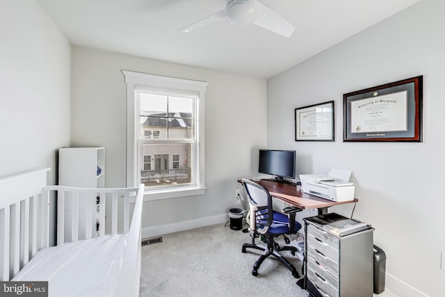 office featuring ceiling fan and light carpet