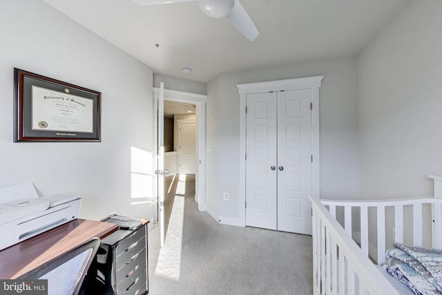 bedroom featuring ceiling fan, a closet, and carpet