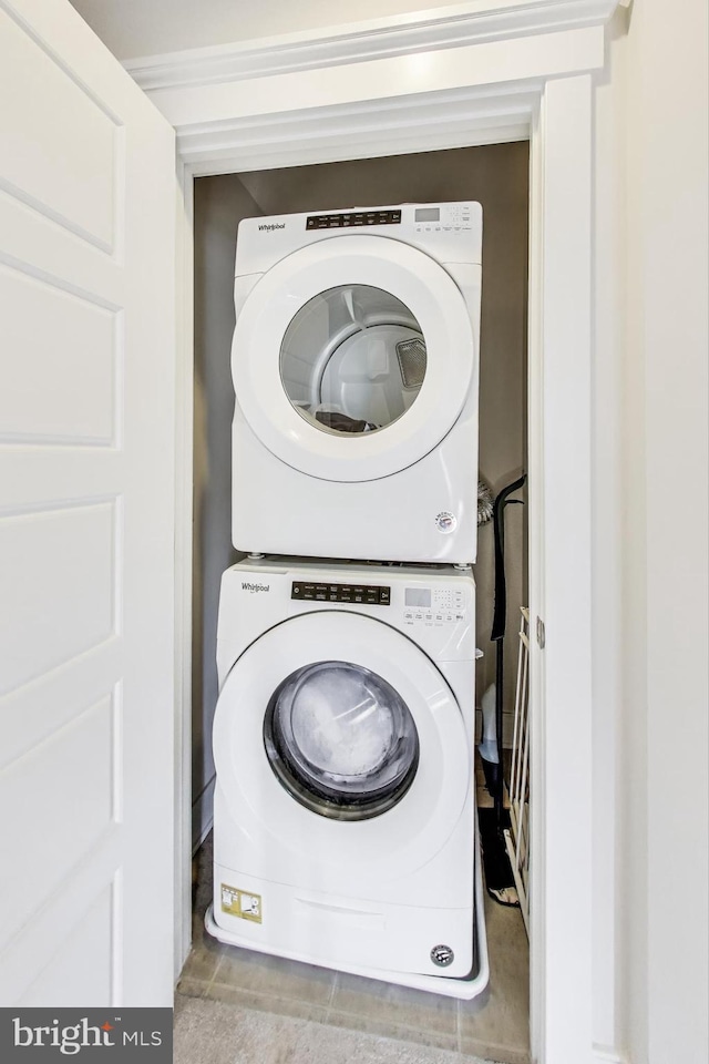 laundry area featuring stacked washer / drying machine