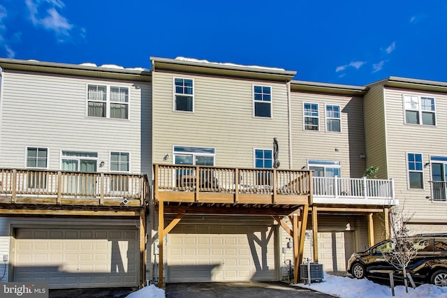 back of house featuring a balcony and central AC unit