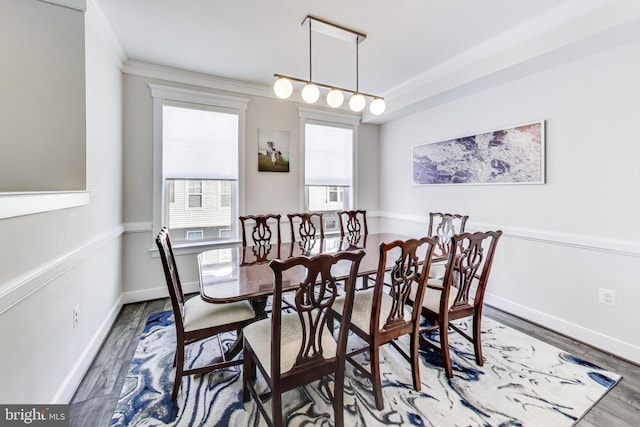 dining room featuring cooling unit, hardwood / wood-style flooring, and crown molding