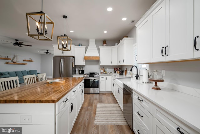 kitchen with white cabinetry, sink, and appliances with stainless steel finishes