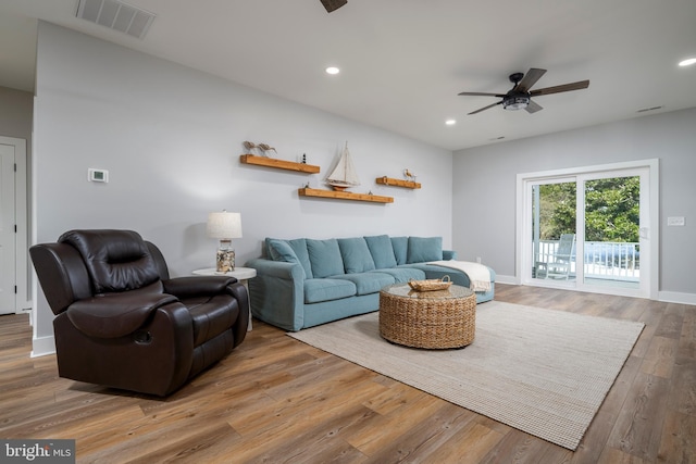 living room with ceiling fan and hardwood / wood-style flooring