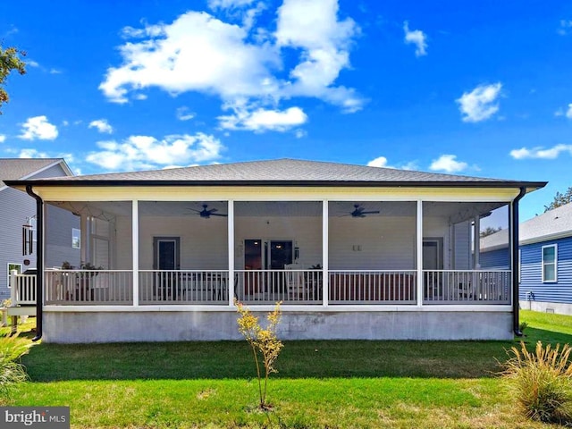 back of house with a sunroom, ceiling fan, and a yard