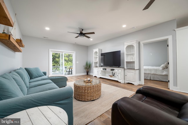 living room with ceiling fan and wood-type flooring