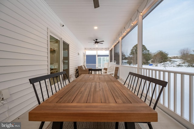 unfurnished sunroom featuring ceiling fan