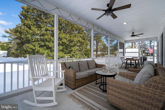 sunroom featuring ceiling fan