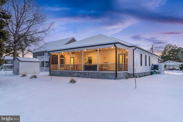 snow covered house featuring an outdoor structure