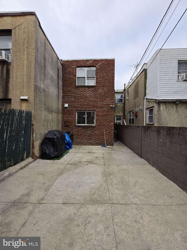 rear view of house featuring a patio area and cooling unit