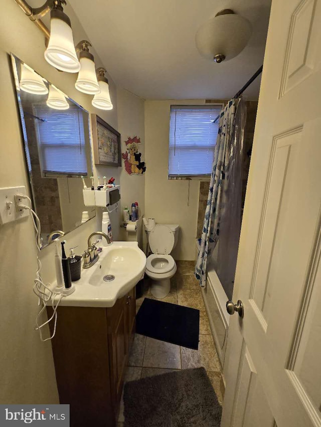 full bathroom with tile patterned flooring, vanity, toilet, and shower / tub combo