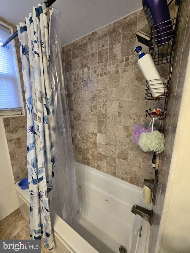 bathroom featuring tile patterned floors and shower / bath combo with shower curtain