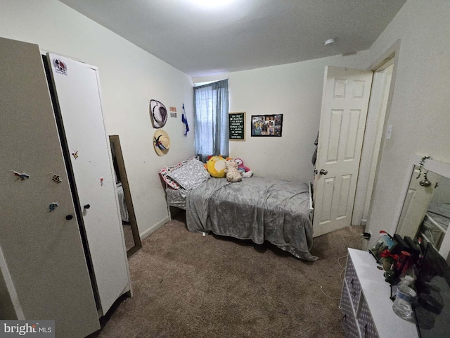 bedroom with dark colored carpet