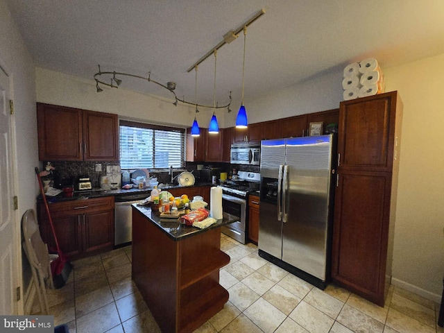 kitchen with pendant lighting, a kitchen island, light tile patterned floors, and appliances with stainless steel finishes