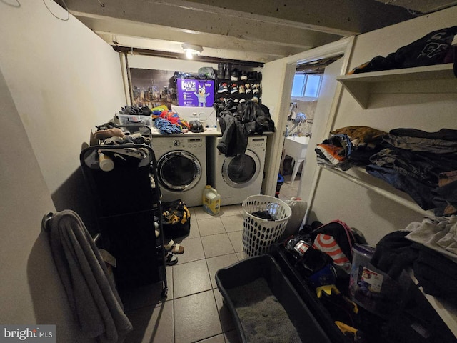 washroom with washing machine and clothes dryer and light tile patterned floors