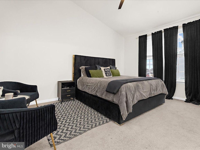 bedroom with ceiling fan, light colored carpet, and lofted ceiling