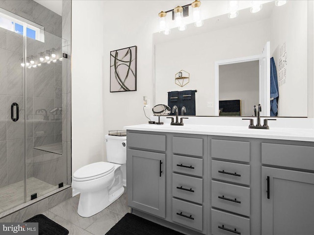 bathroom featuring vanity, toilet, and a shower with shower door