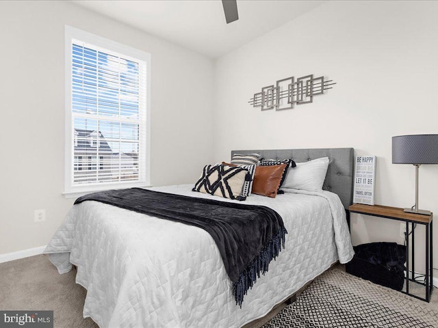 bedroom featuring multiple windows, light colored carpet, and ceiling fan