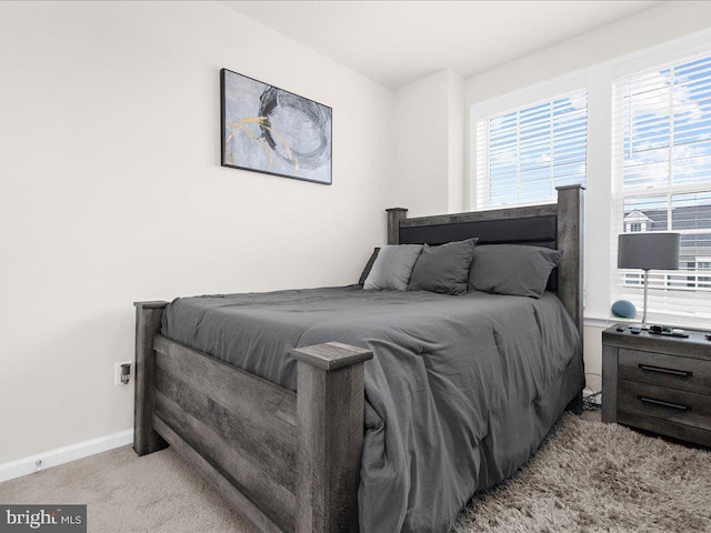 bedroom featuring light colored carpet