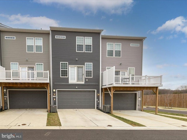 view of front of house with a garage and central air condition unit