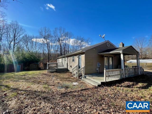 view of side of home featuring a wooden deck