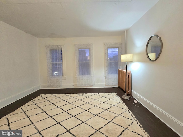 empty room with dark wood-type flooring