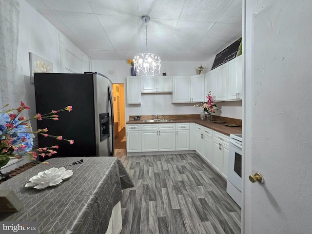 kitchen with white cabinets, white range with electric stovetop, a paneled ceiling, and stainless steel refrigerator with ice dispenser