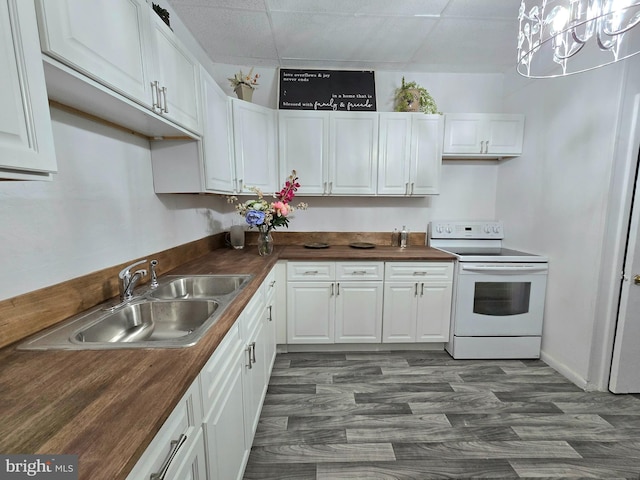 kitchen with white cabinets, sink, white electric stove, butcher block countertops, and a chandelier