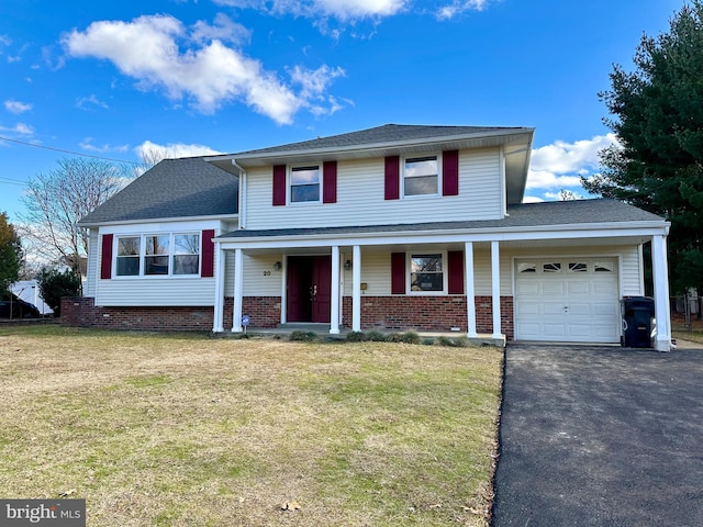 view of front of property with a front yard and a garage