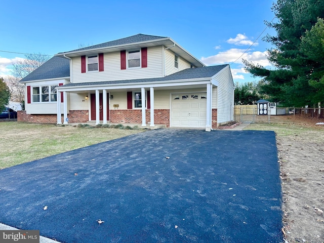 front facade with a front yard and a garage