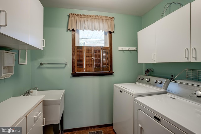 washroom featuring cabinet space, baseboards, and independent washer and dryer