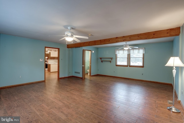 empty room with a ceiling fan, visible vents, baseboards, and wood finished floors