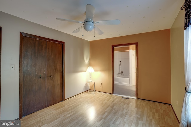 unfurnished bedroom with a ceiling fan, a closet, visible vents, and light wood finished floors