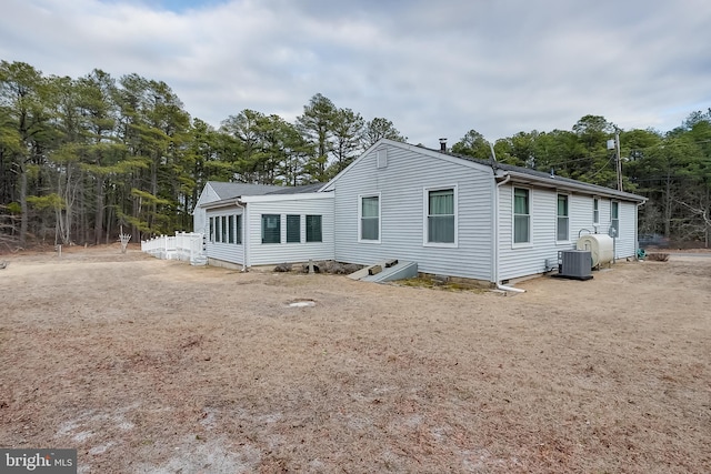 rear view of property featuring central AC